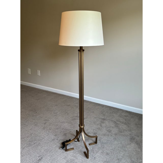 Sophisticated bronze-tone floor lamp attributed to Baker, featuring an elegant neoclassical inspired silhouette with...