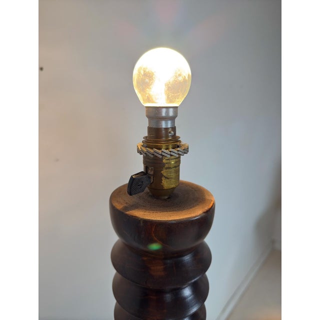 Floor lamp in turned solid wood in the style of Charles Dudouyt Condition: Due to the wood's natural movement over time,...