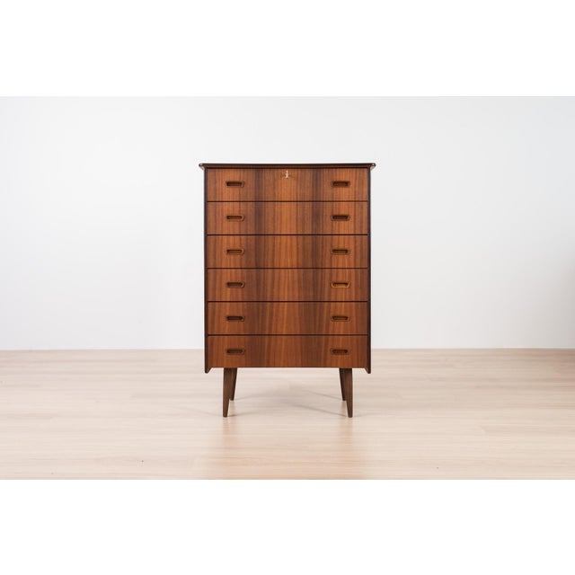 This beautiful teak chest of drawers was manufactured in Scandinavia in the 1960s. It features a simple, elegant form and...