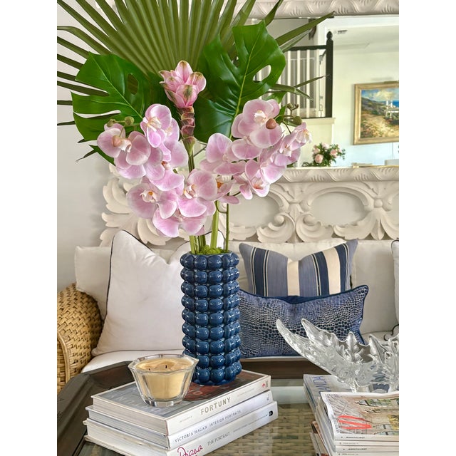 Elevate your space with the effortless sophistication of the Azure Palm Orchid Arrangement - a striking composition...