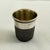 A sterling silver thimble jigger or whiskey shot cup bar tool for measuring out liquor when mixing cocktails. Showing the...