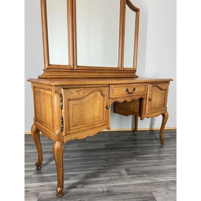 A beautifully crafted Vintage French Louis dressing table , showcasing elegant curves, carved detailing and a warm oak...