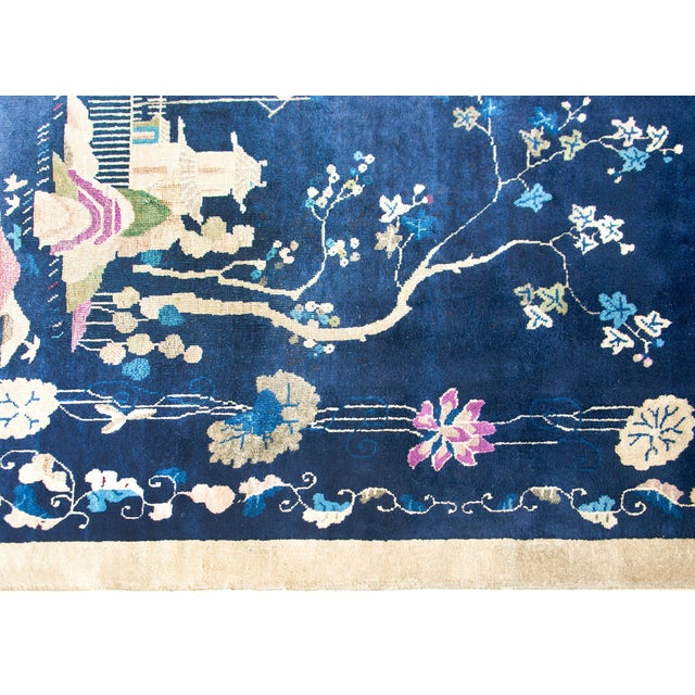 A wonderful early 20th century Chinese Art Deco rug with a dark indigo field surrounded by a lacy floral and scrolling...