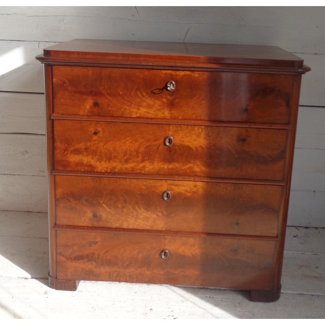 Exceptional Biedermeier chest of drawers with secretaire under sliding shelf. The chest of drawers is in fine mahogany,...
