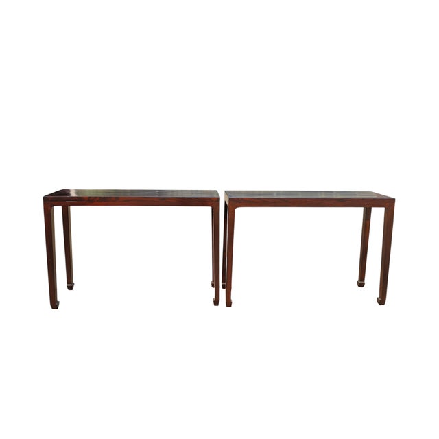 This pair antique console table features a minimalist silhouette with a narrow, elongated profile. Finished in a deep...