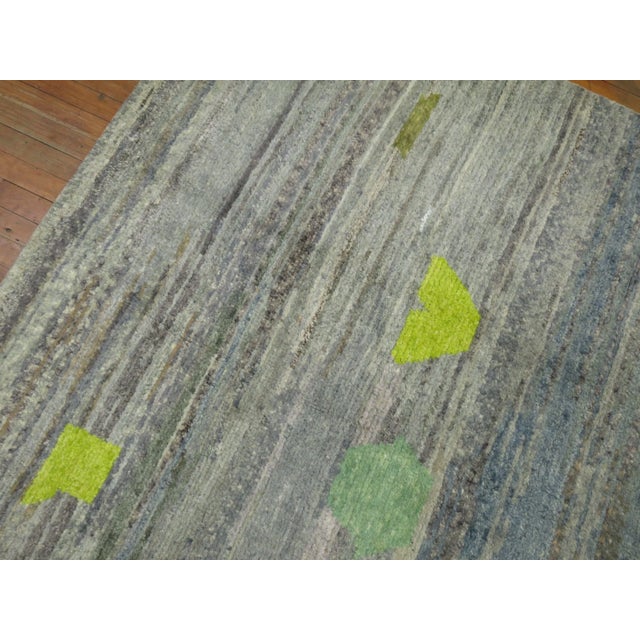 Room size Turkish Rug with a Contemporary Abstract Like Motif on a gray blue field. The rug is a one of a kind , Hand-...