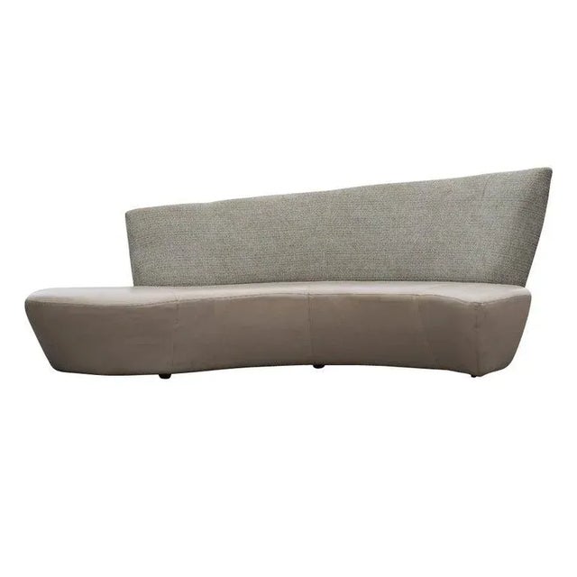 A sculptural modern sofa designed by Vladimir Kagan and inspired by the curves and undulations of the Guggenheim Museum in...
