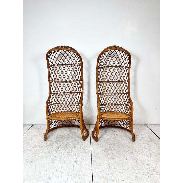 Vintage pair of hooded dome rattan chairs. Open basket weave pencil reed rattan frames with cane wrapped joints and woven...
