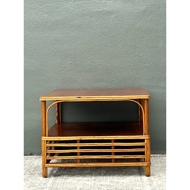 This vintage side table is a masterful example of Mid-Century Modern coastal design, featuring a striking frame crafted...