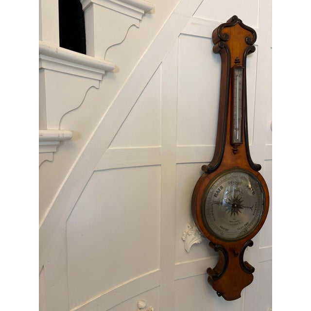 A fine antique victorian english wheel barometer by g & l guanziroli of hatton garden london, housed in a beautifully...