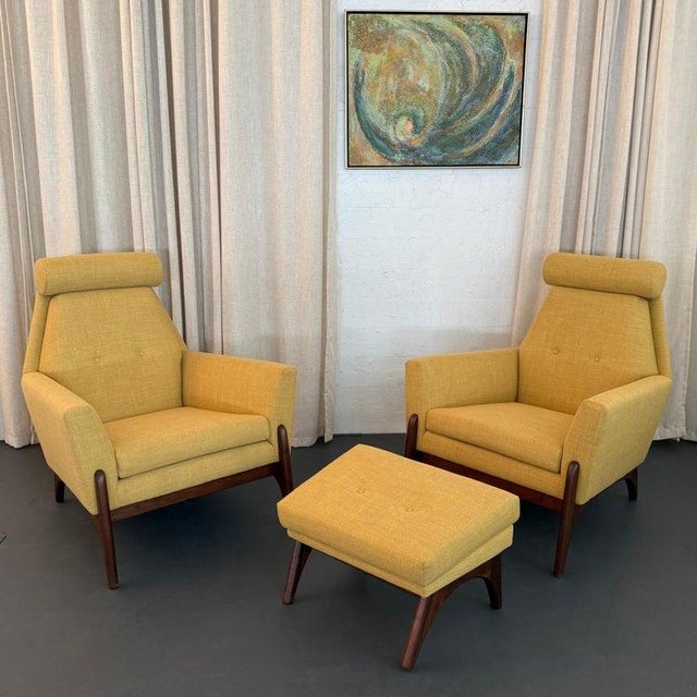 This set of two Mid-Century Modern, high-back lounge chairs with a matching ottoman is American made circa the 1960s. The...