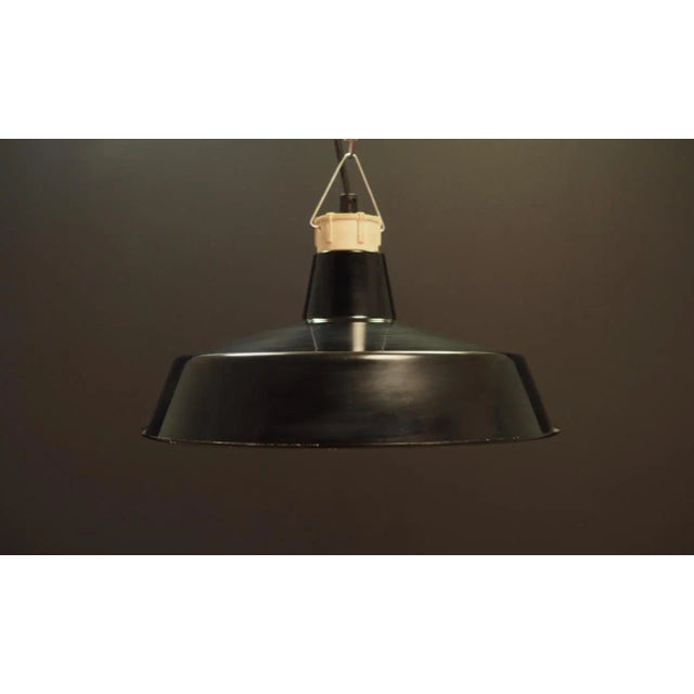 The lamp was made in the 1960s, Danish production. Made of metal in colour: black. The disc-shaped construction is not...