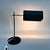 Space age metal table or desk lamp. The shade is adjustable to the sides and can also be moved forward and backward as...