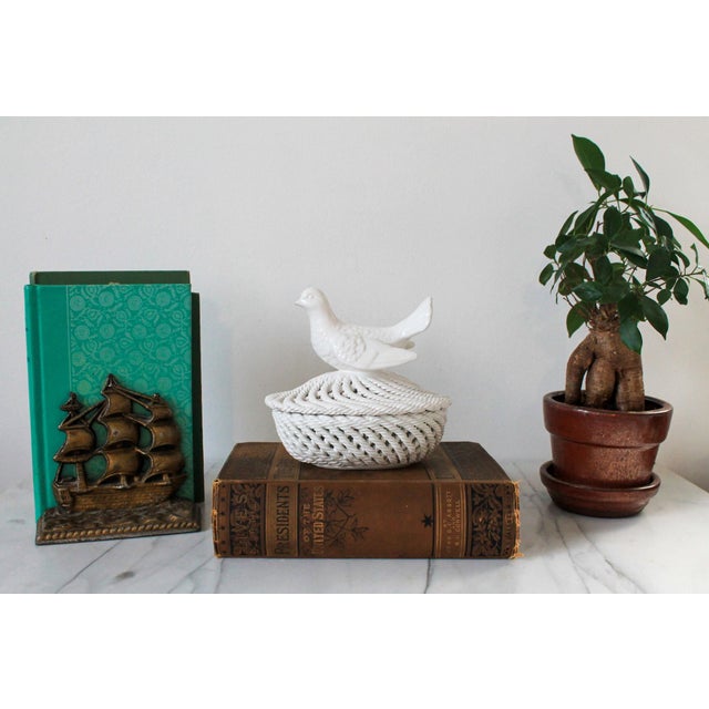 Vintage lidded porcelain braided rope trinket dish with dove motif. No makers mark. Some areas of wear to paint. Pictured.