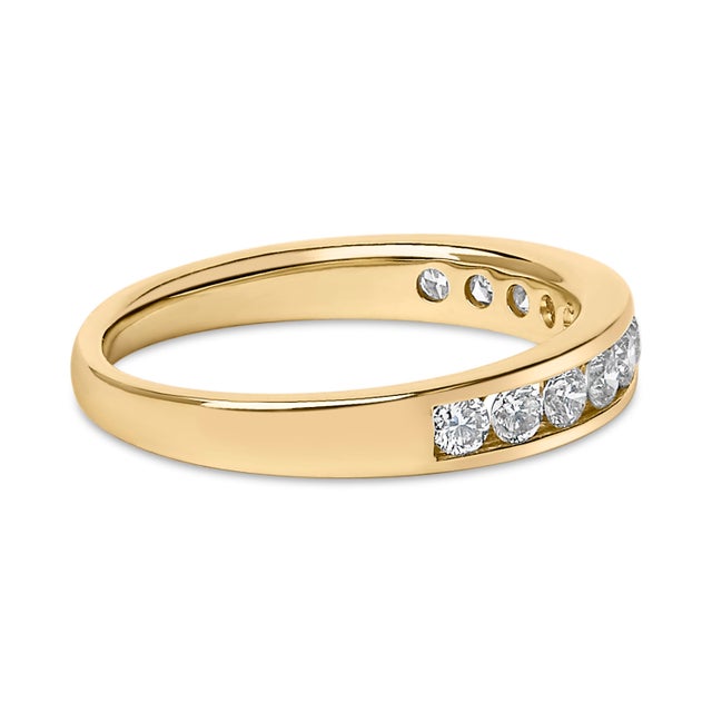 Embrace timeless elegance with this meticulously crafted 14k yellow gold wedding band, adorned with a row of 11 natural,...