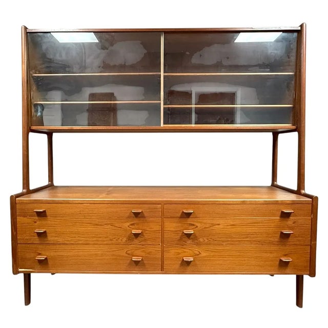 A classic mid-century modern piece by renowned Danish designer Hans J. Wegner. This RY-20 Mobler teak hutch and sideboard...