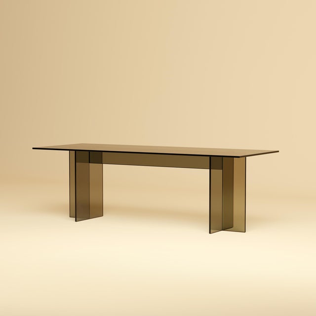 The Noor is a bronzed glass lounge table, a low, elongated table for the space in front of a sofa in which the material is...