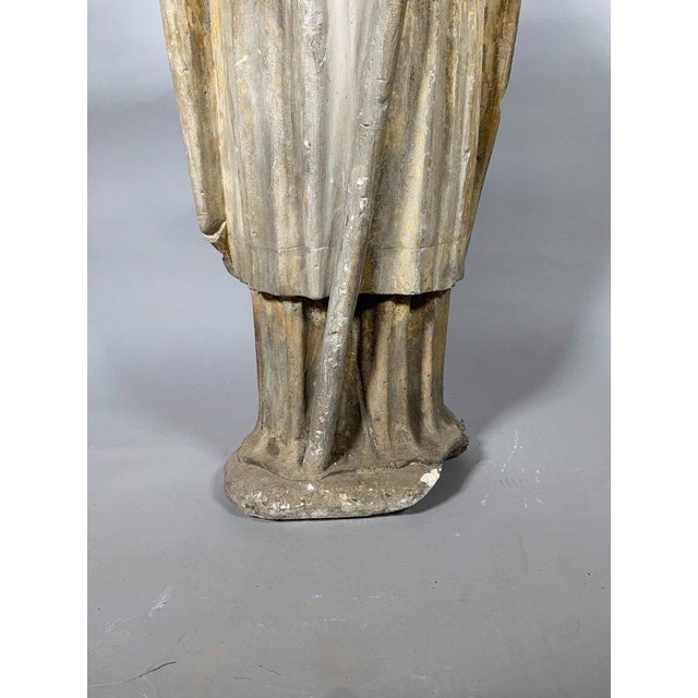 15th-century limestone sculpture of a standing bishop, Saint Bishop, wearing a mitre and holding his episcopal staff in...
