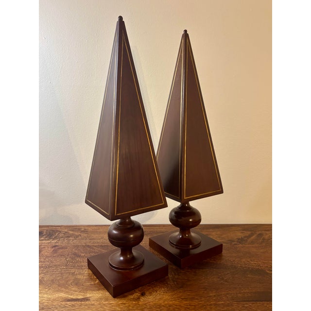 A refined pair of vintage wooden obelisks crafted in solid wood, combining classical architectural form with warm,...