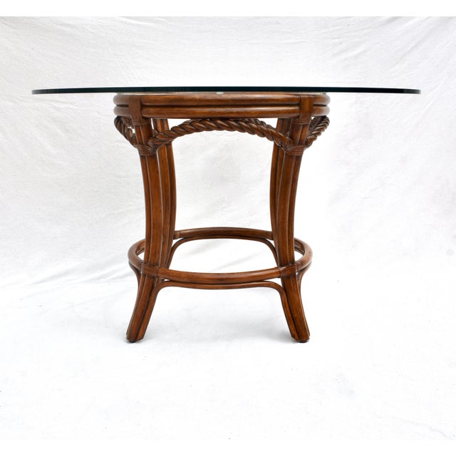A fine pedestal dining / center or game table of solid wood faux bamboo and twisted rope styling, accented with leather...