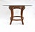 A fine pedestal dining / center or game table of solid wood faux bamboo and twisted rope styling, accented with leather...