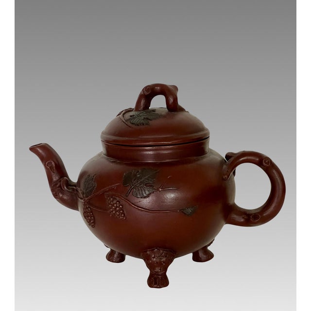 An impressive and signed / artist chopped / hall marked fine Yixing Zisha unglazed teapot topped with a Vine finial/knob....