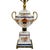 A sophisticated vintage porcelain table lamp featuring a classic handled urn-shaped body mounted on a footed brass base....
