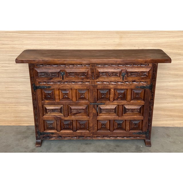 From Northern Spain, constructed of solid walnut, the rectangular top with molded edge atop a conforming case housing two...