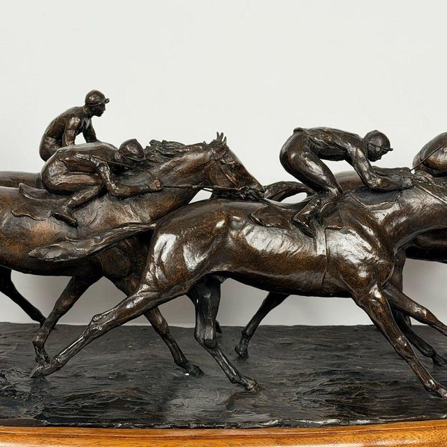 A superb limited edition bronze study of five racehorses and their jockeys racing. Excellent deep brown patination and set...