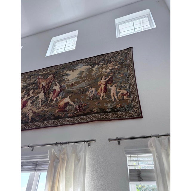 Monumental woven tapestry wall hanging depicting an elaborate classical pastoral scene with robed figures, putti and...