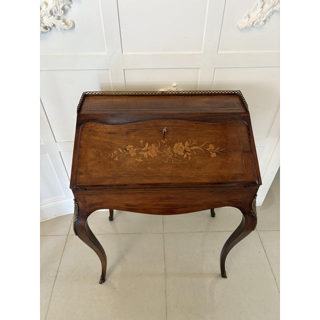 Antique Victorian French quality rosewood marquetry inlaid bureau having the original ornate brass gallery above a quality...