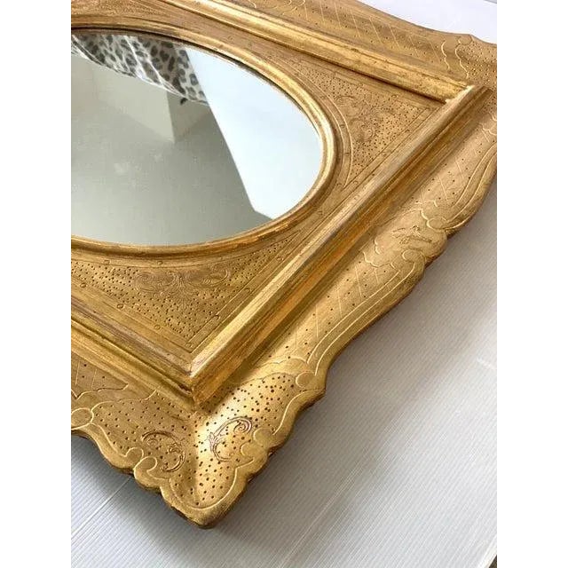 Venetian mirror in solid linden wood, hand carved and finished in gold leaf, fruit of high italian craftsmanship. l.65 cm...