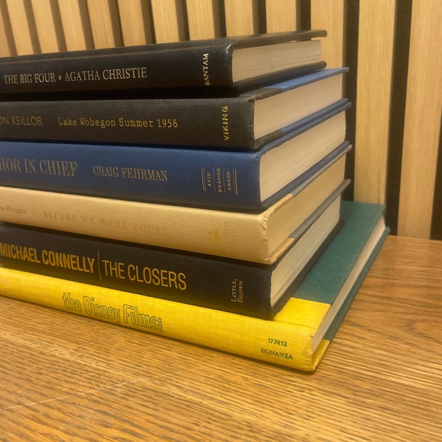 A thoughtfully curated decorative book stack featuring classic and contemporary literary titles, unified by a refined...