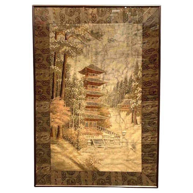 A Japanese silk embroidery landscape scenery panel depicting a Buddhist pagoda and a temple compound set in a forest with...