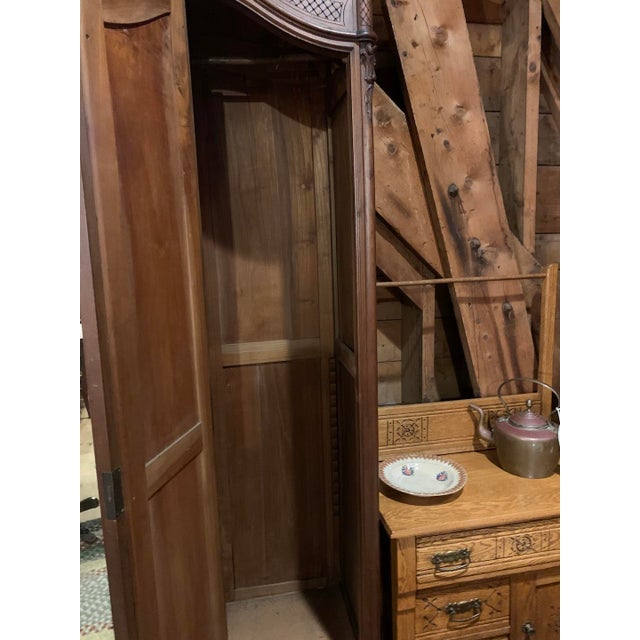 Antique French walnut three-door armoire with lovely carving and good color. The mirrors have bevelled glass - no repairs...