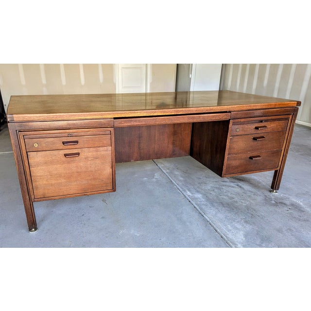 This is a mid 20th century Jens Risom executive desk, manufactured in the late 50s, early 60s of American walnut veneer...