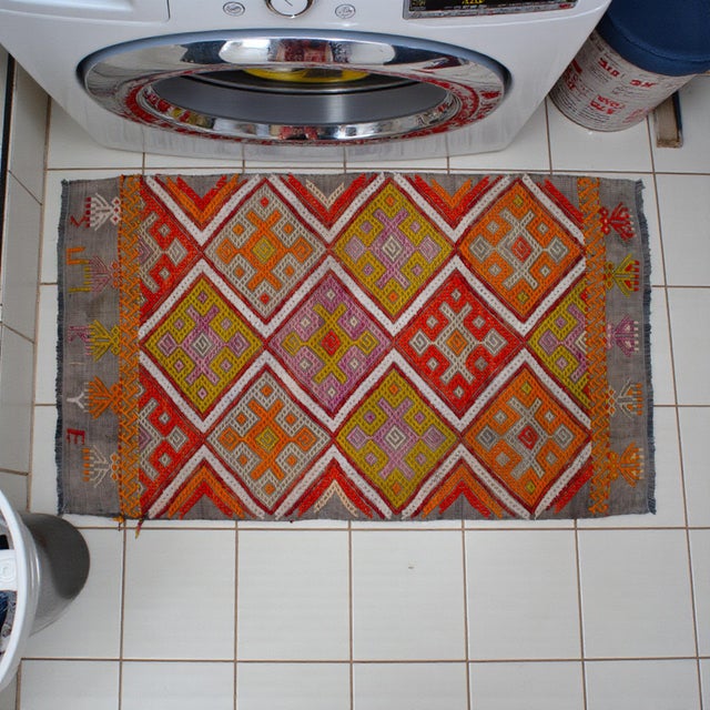 This authentic vintage Turkish Cicim is a masterpiece of nomadic art, showcasing a sophisticated raised-pattern texture...