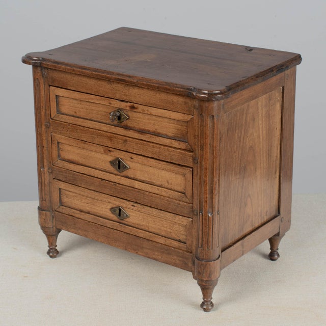 An early 19th century French Louis XVI style miniature sampler commode, hand-crafted of solid cherry wood. Nice...