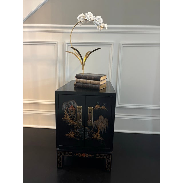 Offered is a rare accent table with double doors that open to ample storage space. This piece features a timeless...