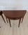 Constructed during the nineteenth century, this pair of half-moon tables was made in England and follows the demi-lune...