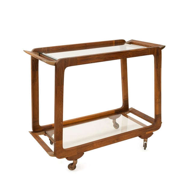 Crafted from rich teak wood with a warm finish, this sleek rectangular design features two tinted glass shelves that...