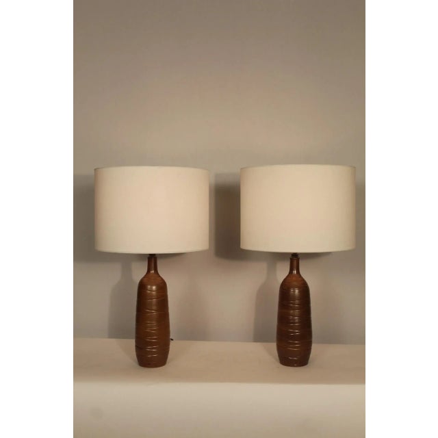 Pair of unusual stoneware lamps. Beautiful Taupe glaze, with circular etching. Giving both depth and texture. Petite in...