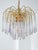 Elegant 1970s Murano glass chandelier attributed to Paolo Venini, featuring a gilded metal frame with cascading clear...