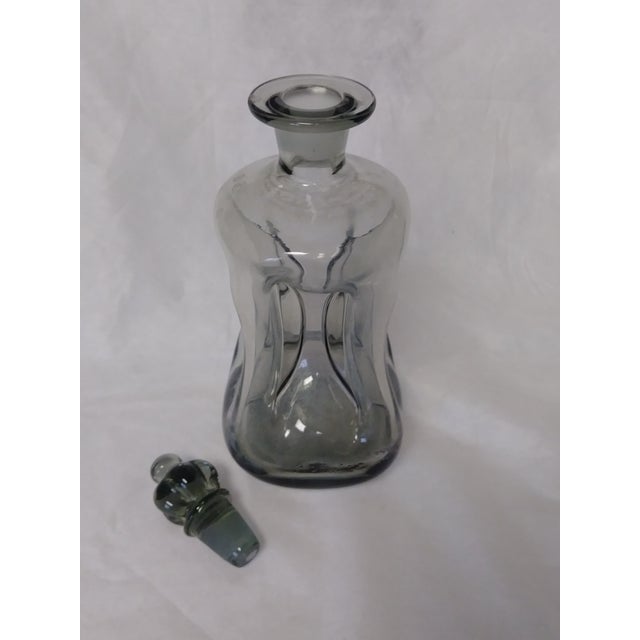 This Danish decanter designed by Jacob E. Bang for Holmegaard of Denmark has a crown glass top different from others (most...