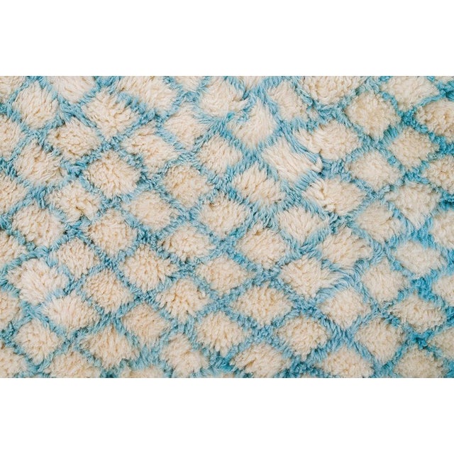 Textured hand-knotted wool rug in a serene blend of Blue and Ivory, featuring a subtle diamond lattice pattern. Perfect...