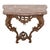 A rococo marble top carved wood wall mount console table. The hand-carved apron and supports showcase elaborate...