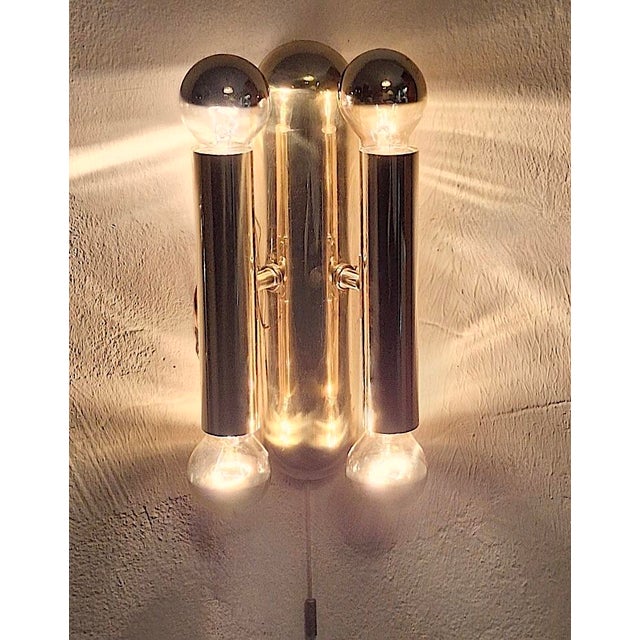 Elegant mid-century pair of brass wall lamps each with 4 lights, Italy 1960s. Up to 250V (Europe/UK Standard).The wiring...
