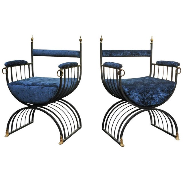 Pair of Mid Century Roman inspired Savonarola chairs in iron with brass finials and ornamentation. Upholstered in Blue...