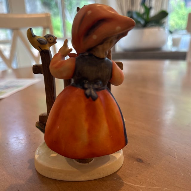 Goebel Hummel intricate figurine Signs of Spring. Young girl is blue and orange dress with white dots. Great condition....