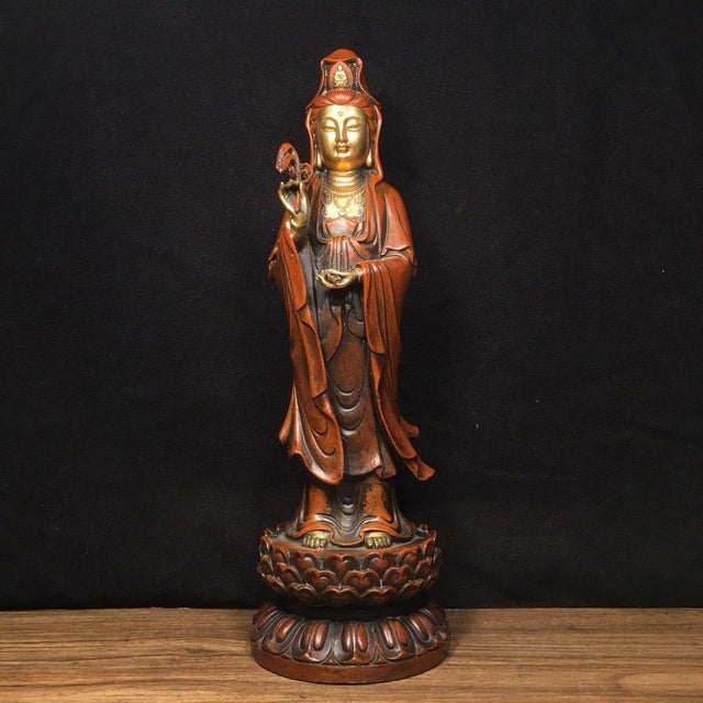 A serene and majestic vintage sculpture of Guanyin (Avalokiteshvara), the revered Bodhisattva of Compassion. Standing at...